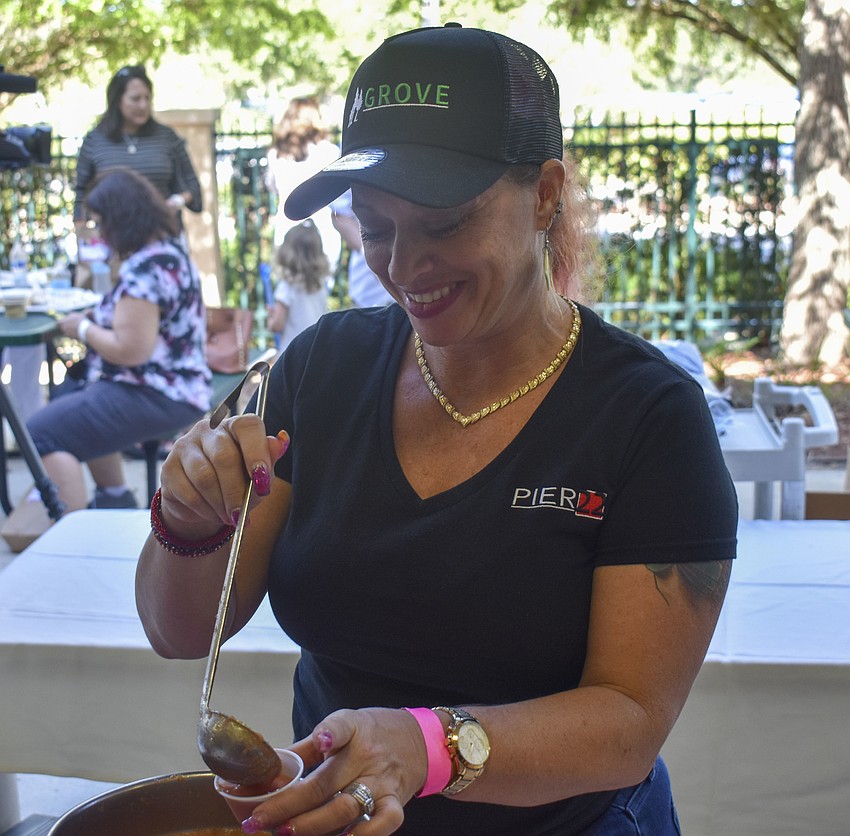 Jen Hicks from Pier 22 ladles gazpacho into a sample cup.