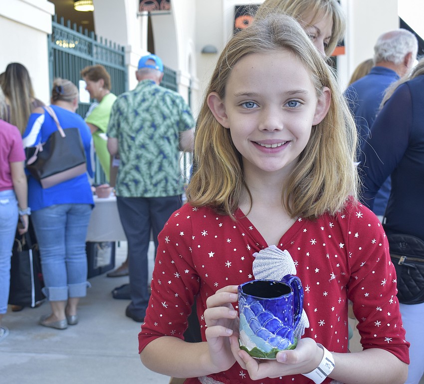 Katie Dick, 9, picks out her new mug.