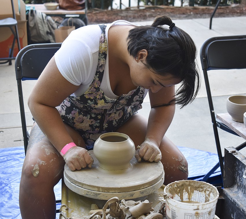 State College of Florida student Sara Damasco sculpts a new bowl.
