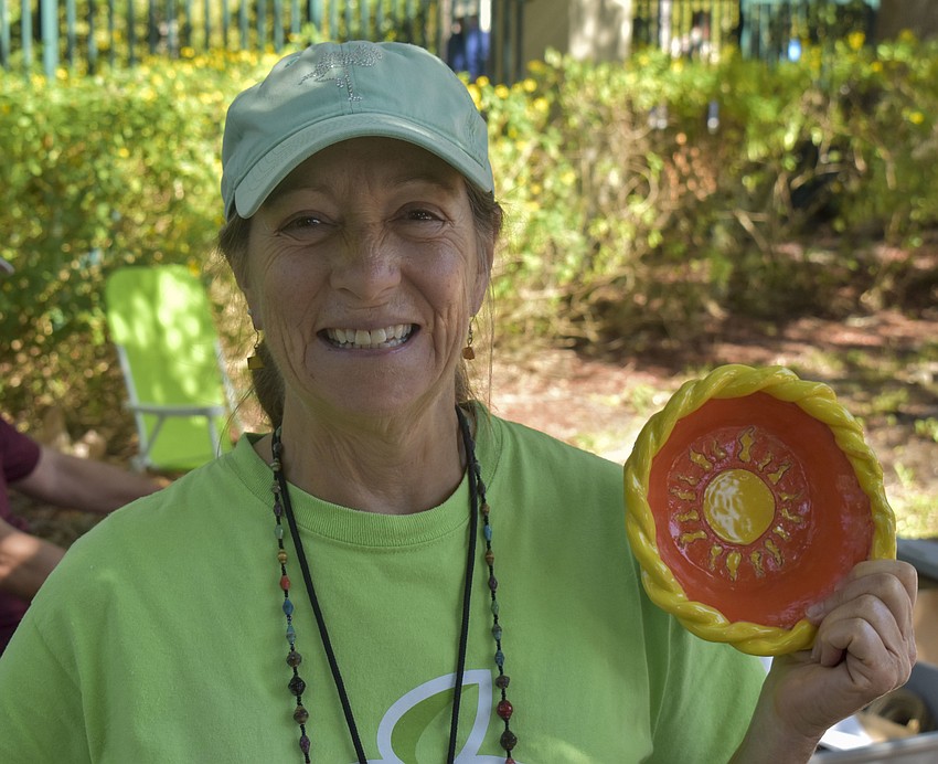 Trina Creek holds up one of the bowls for sale.