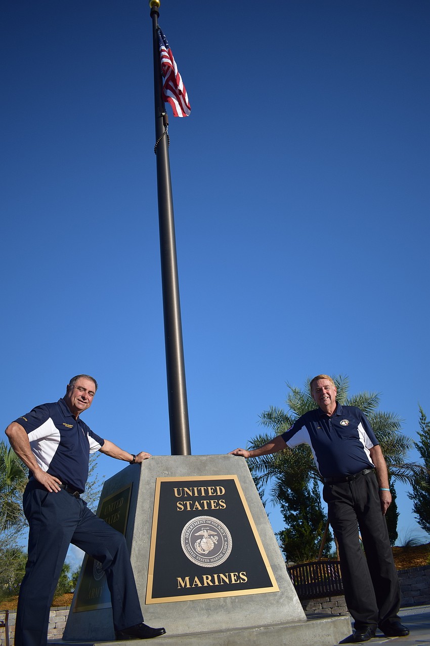 Herman Martinez and Jerry Hufford stand alongside the Circle of Honor memorial that was dedicated by the Association of Veterans and Military Supporters and the Pulte Group Southwest Florida Division at Del Webb.