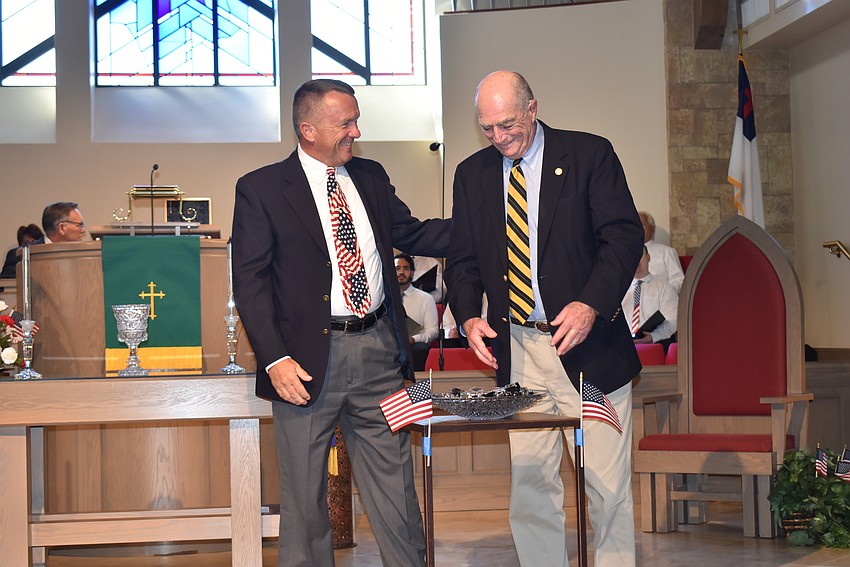 Scott Wuesthoff and Stanley Minken as they prepare to give out pins.