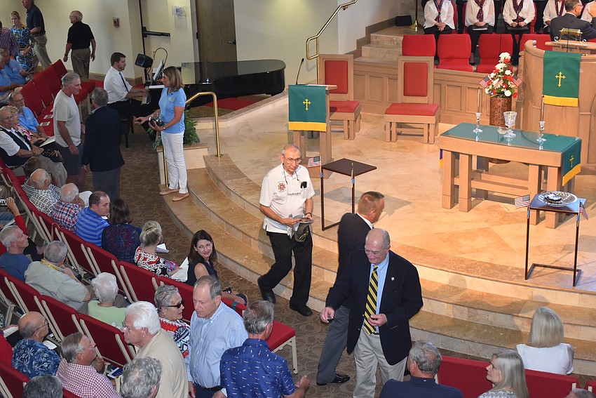 Stanley Minken and Scott Wuesthoff bestow Vietnam veterans with the pins.