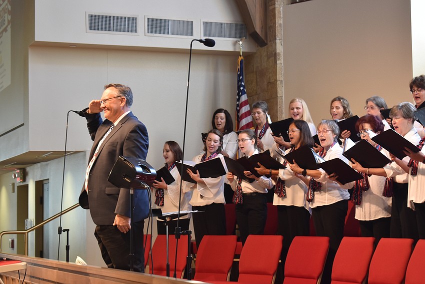 Joseph Holt salutes the crowd during the medley of military service songs.