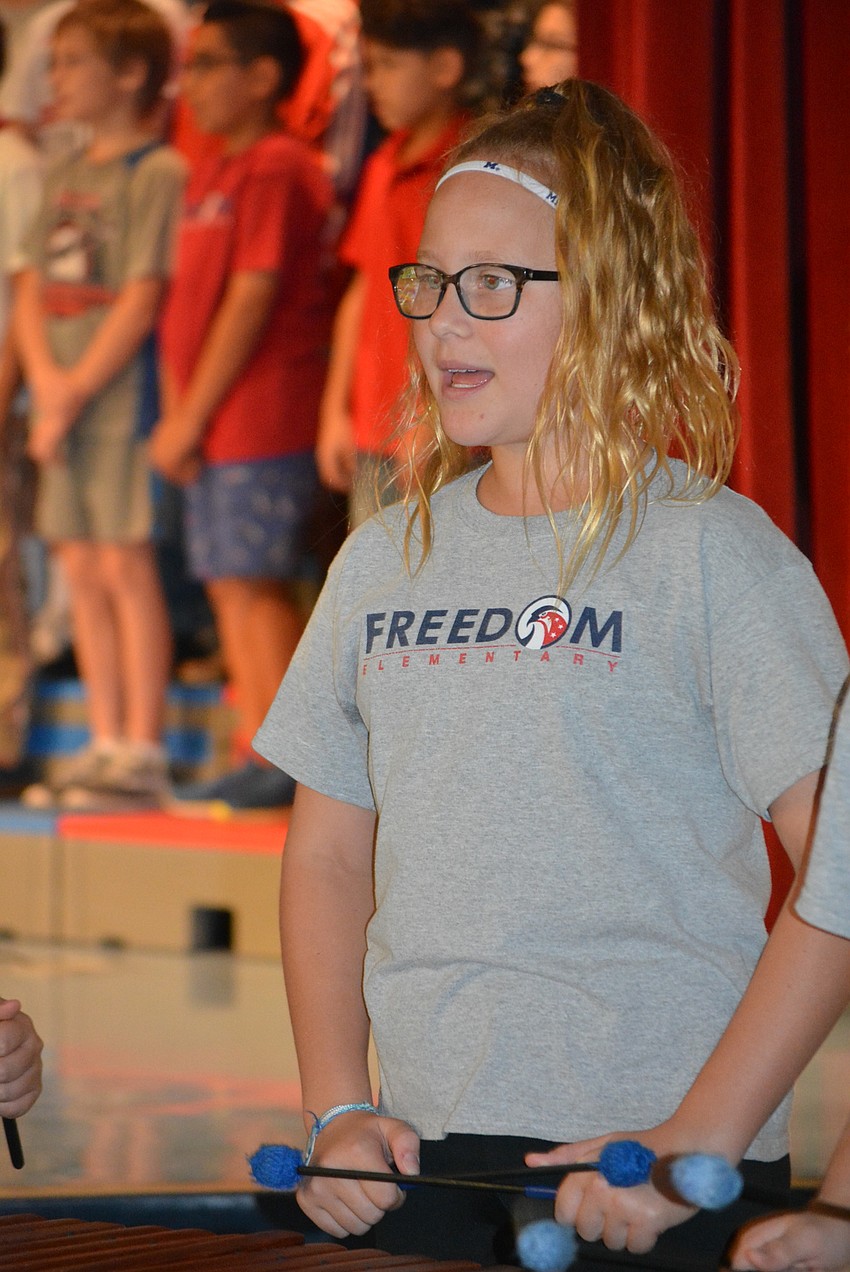 Jordan Seacat is one of about six students to play an instrument during part of the performance.