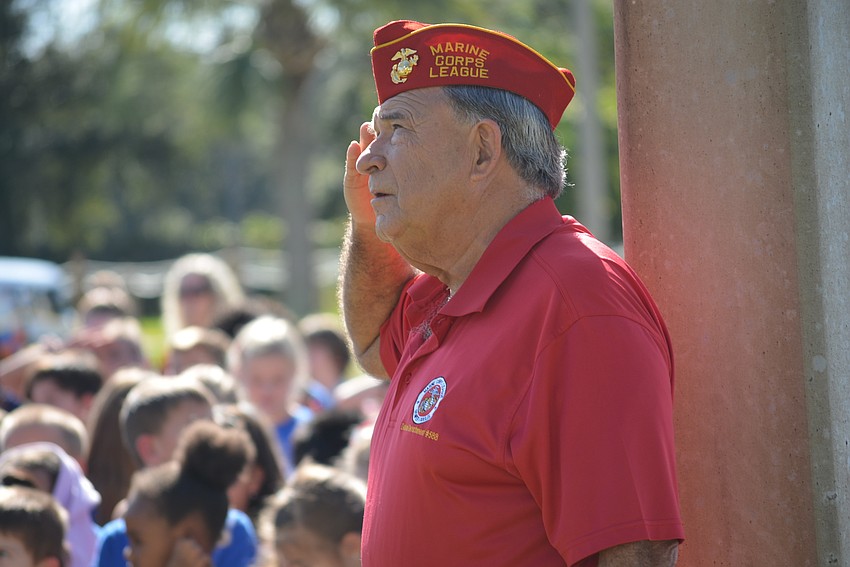 School District of Manatee County School Board member Dave Miner, a military veteran, salutes for the raising of the American flag.