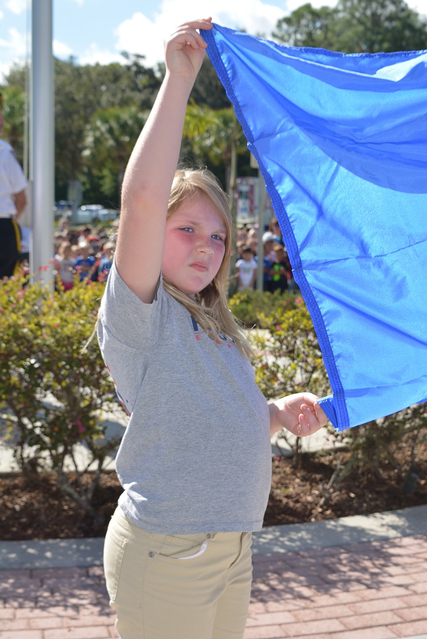 Third-grader Addison Creel helped raise the flag for the U.S. Navy.