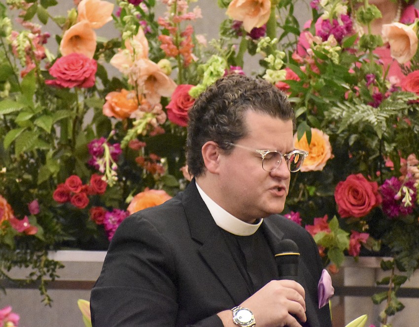 Father Charleston Wilson leads the crowd in prayer.