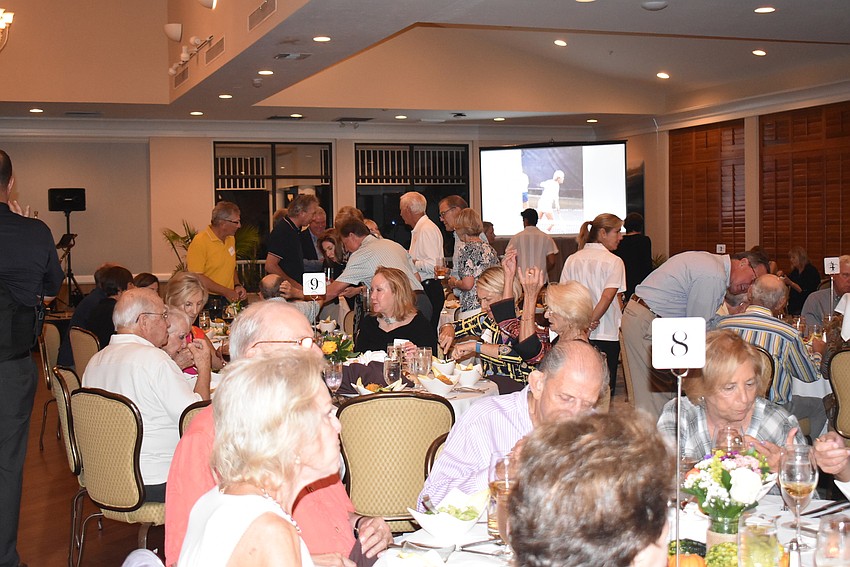 Due to rain, the event was moved mostly inside and the Harbourside Ballroom was crowded with tennis players.