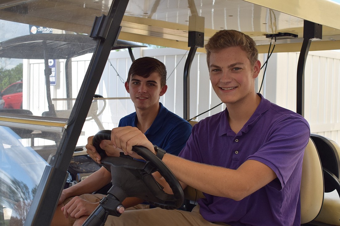 Out-of-Door Academy seniors Andrew Dowdell and Brian Lutton are working to convert Lutton&#39;s golf cart from gas to solar power. They will then use it as a model to convert ODA&#39;s eight golf carts to solar power.
