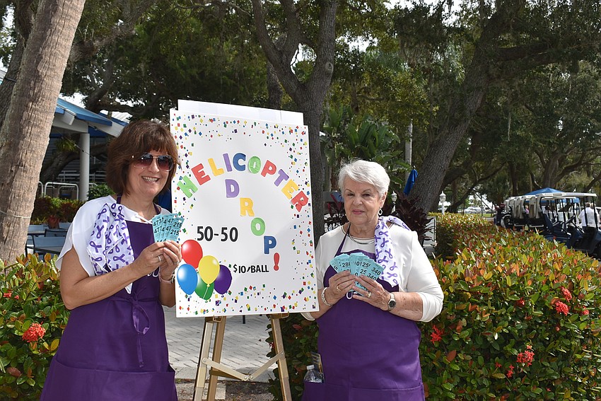 Maryanne Pisani and Annette Seibert sell raffle tickets.