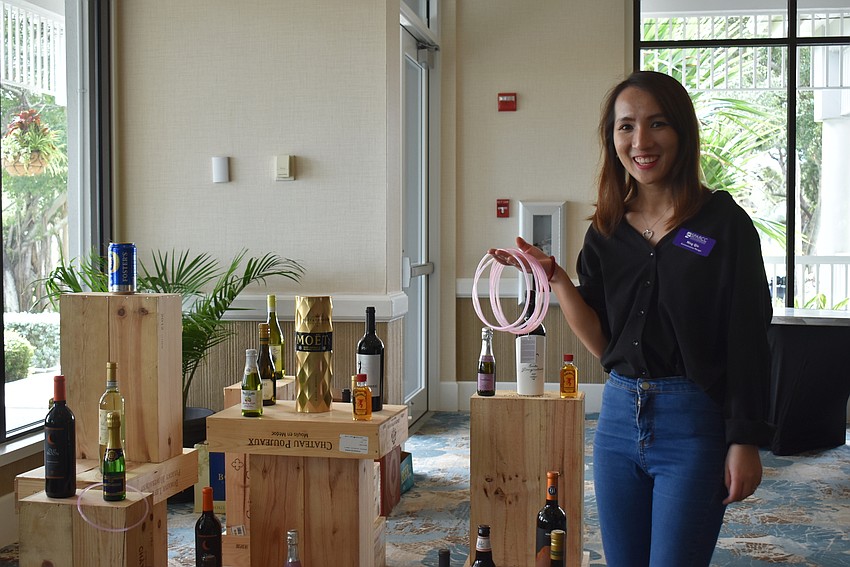 Ning Qin poses with the rings to be tossed.