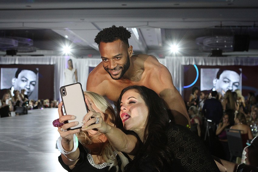 Brandi Beckstein and Leasha Flammio grabbed a photo with a model.