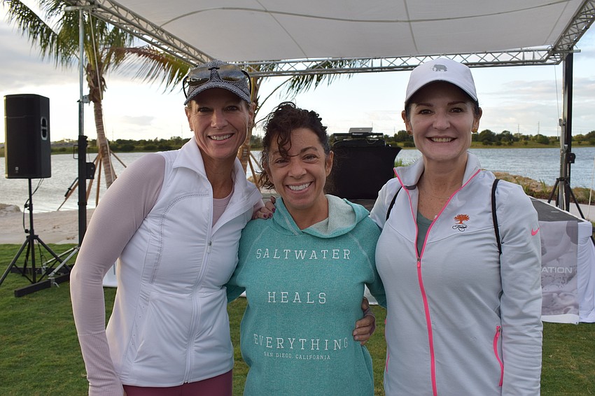 Lakewood Ranch's Christy Comito, Lisa DeFalco and Sonia Levy head toward the 5K start after picking their yoga spots.