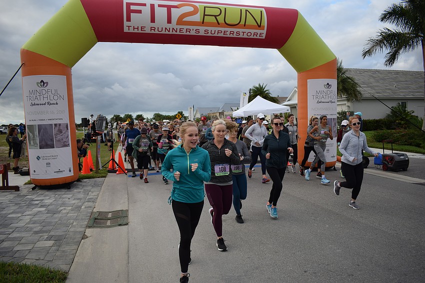Sarasota's Ava Brown leads the pack out of the starting gate for the 5K.