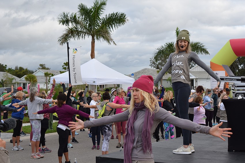 Boston's Trish Hart, who led the meditation portion of the event, and Yoga Shack owner Courtney Smith (above) warm up the runners before the 5K.