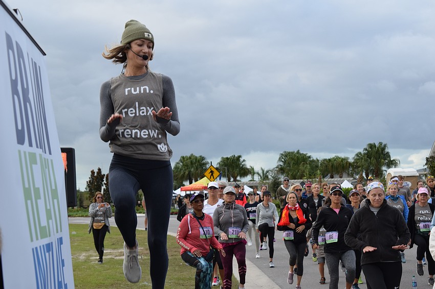 Yoga Shack owner Courtney Smith gets the entrants to do a little high leg kicking before the 5K.