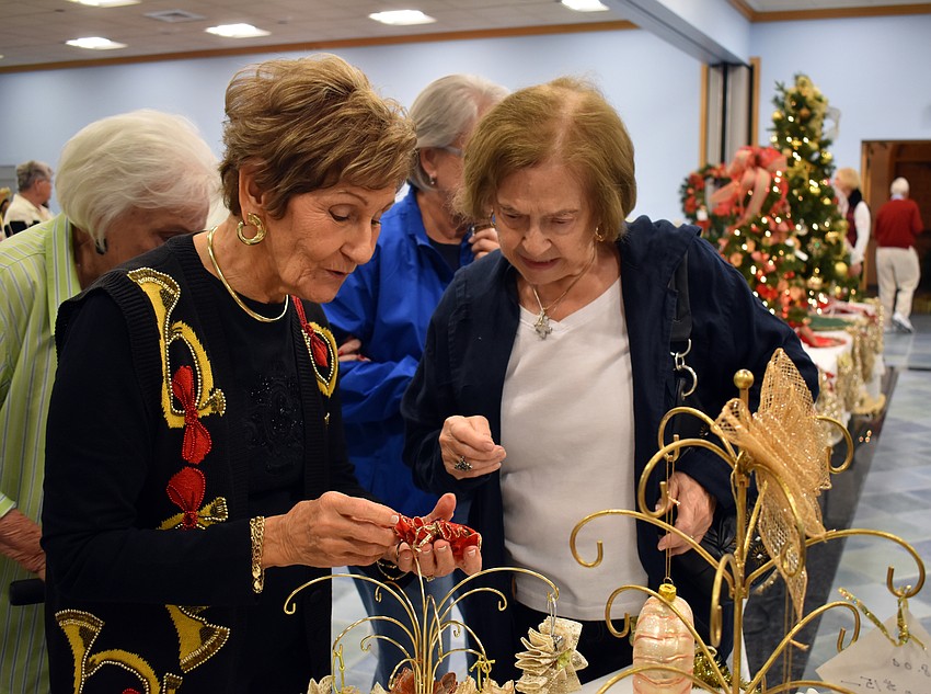 Jane Vorel helps Rosella Quattrone find ornaments in the right colors.