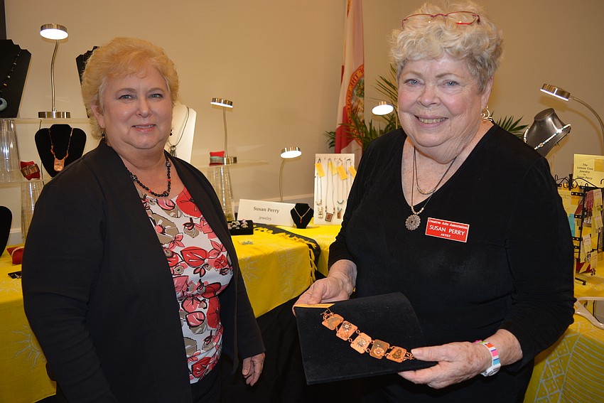 Sharon Kenney assists artist Susan Perry with jewelry from  her brand, 