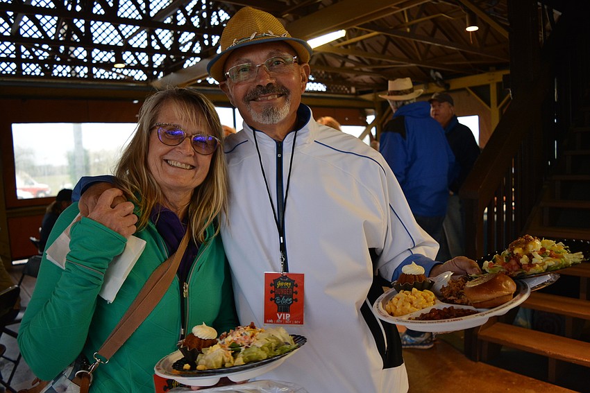Siesta Key residents Susie and John Viqueira  enjoy food in the VIP pavilion.