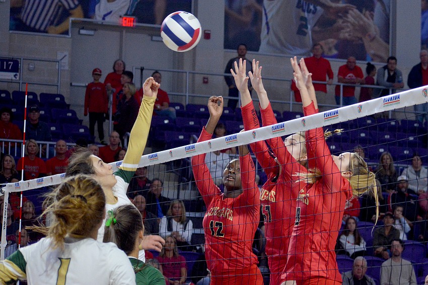 Jordyn Byrd, Anna Klemeyer and Mary Page go for a block.