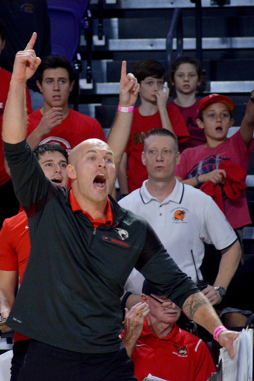 Cougars coach Chad Sutton celebrates winning a point.