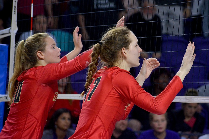 Mary Page and Anna Klemeyer prepare to leap for a block attempt. The Cougars had 14 total blocks in the match.