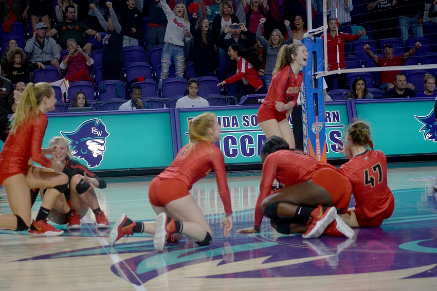 The Cougars fall to the floor in joy after securing the state title against Westminster Christian.