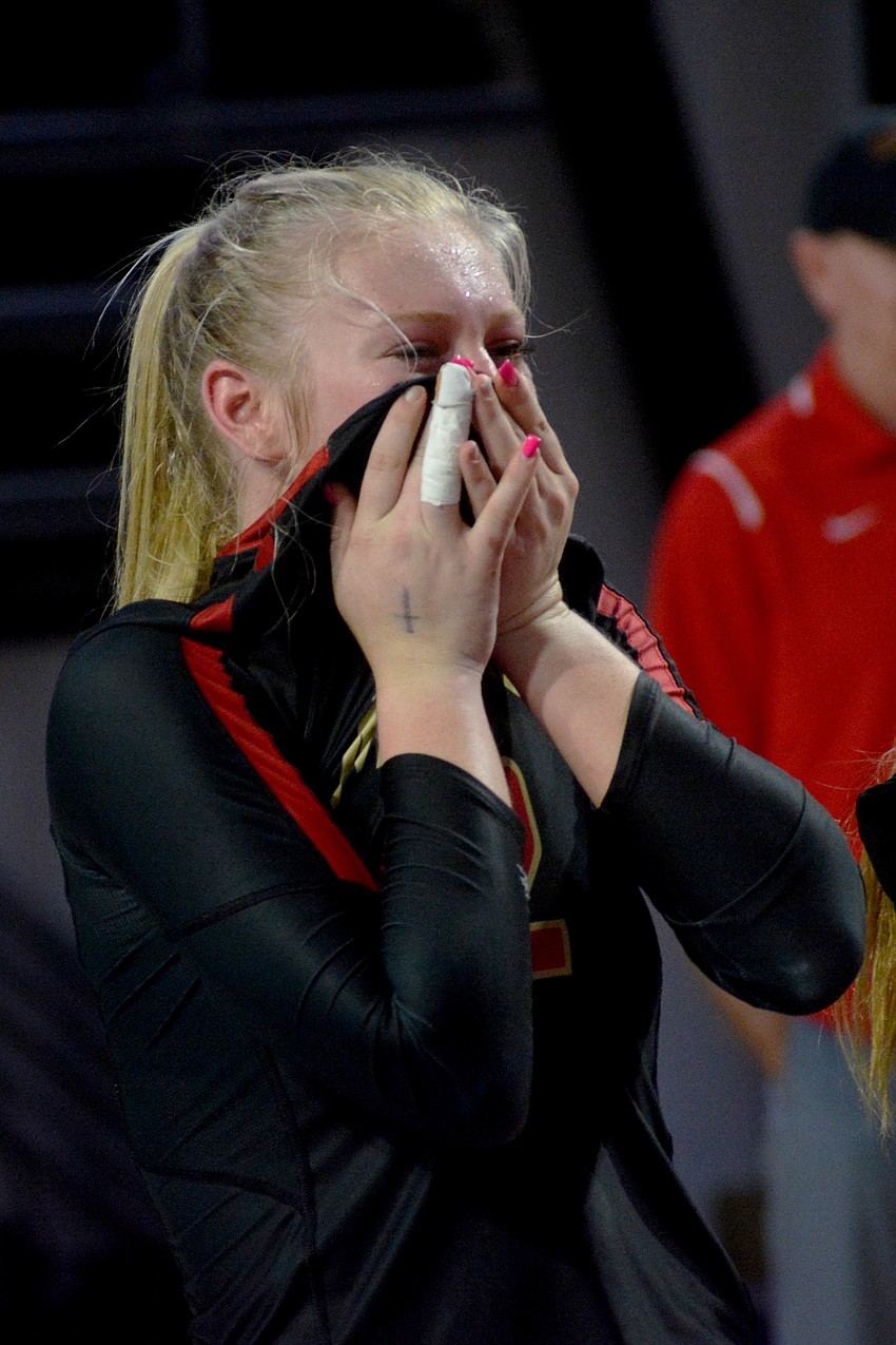 Madison Brown wipes joyous tears from her face.