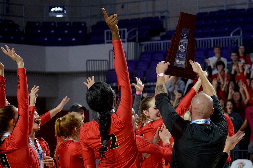 The Cougars show off their state championship trophy.