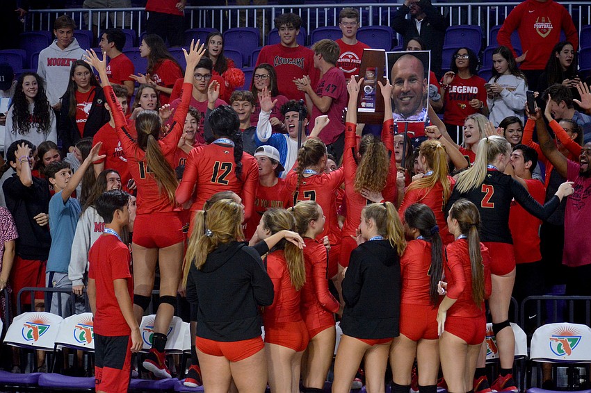 The Cougars hop into the student section to celebrate with their fans.