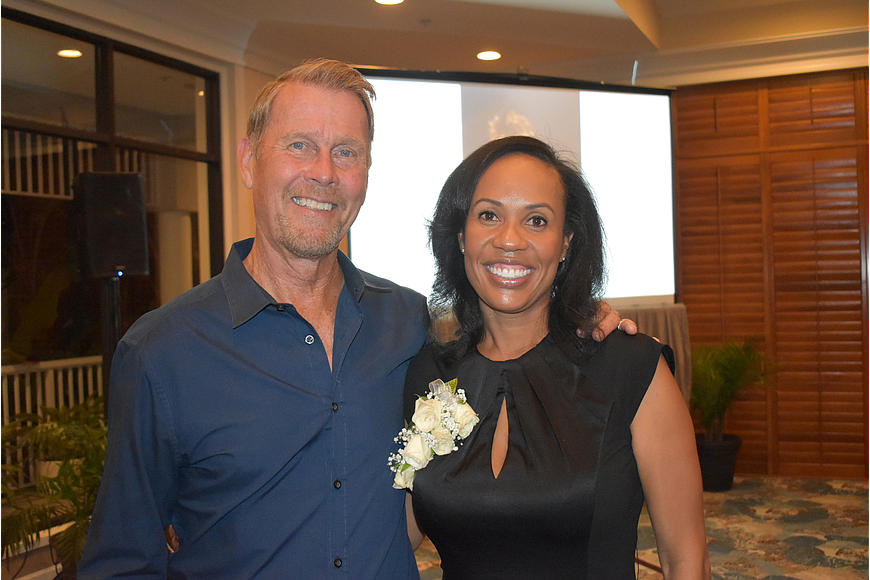 Briana Harris Francois (right) and John Woods stand together at the Longboat Key Club Tennis Association&#39;s annual Fall Frolic. Harris Francois is succeeding Woods, the only director of tennis in club history.