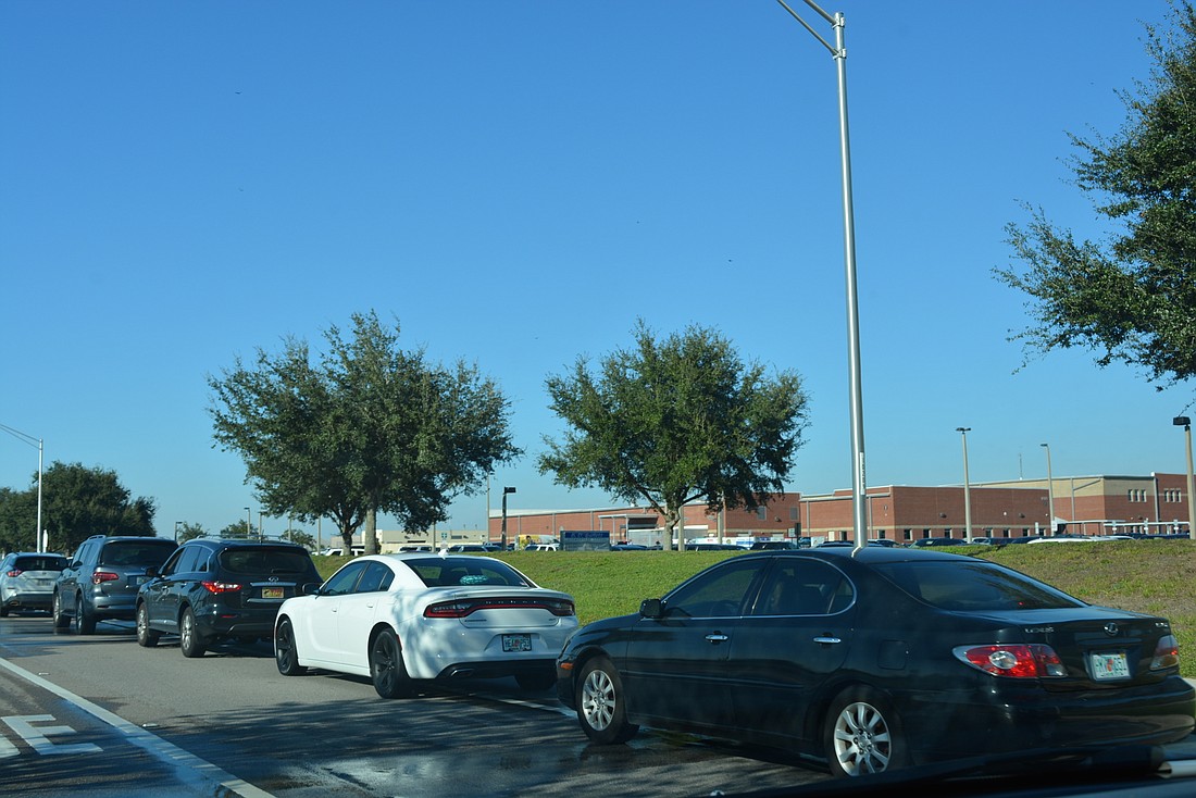 Vehicles waiting in line to pick up children as school lets out at B.D. Gullett Elementary School spill onto Wood Fern Terrace. Stopping in traffic lanes there now will be prohibited.