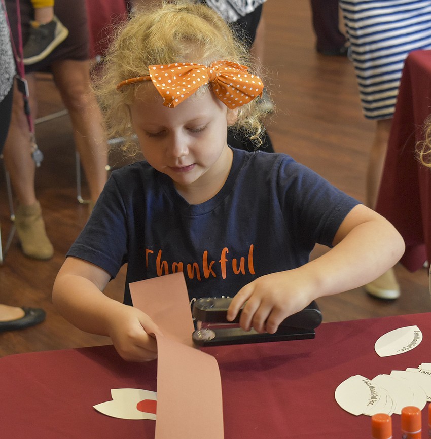 Olivia Bressan makes her turkey hat.