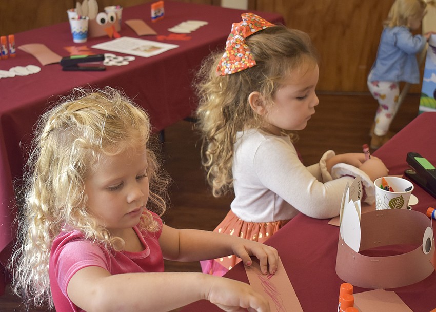 Lisle Christensen and Audrey Helmuth make turkey hats.