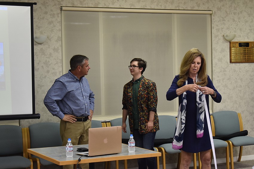 Kevin Greene, Kai Sacco and Lyn Haycock as she rips raffle tickets for members.