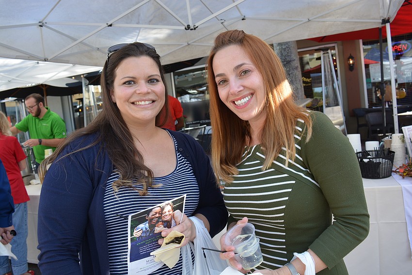 Neal Signature Homes' Renee Wilson, with friend Nicole Nisi, settles on her soup choice — chicken poblano soup from the Grove.