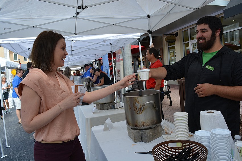Bradenton's Kelly Camrath selects a tomato blue cheese soup made by Central Cafe. It's served up by Publix employee Pedro Irimia.