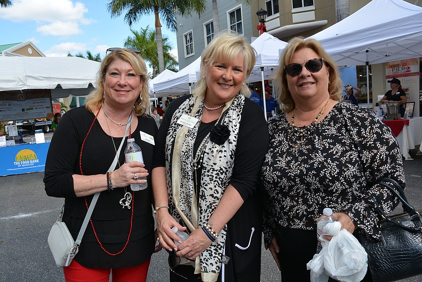 Meals on Wheels PLUS Vice President of Events and Volunteer Engagement Judi Bjork  and President and CEO Maribeth Phillips chat with friend Annmarie Kuffer, of Synovus Bank.