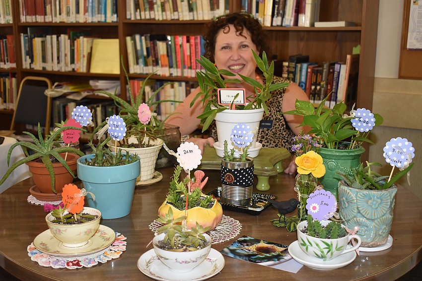 Linn Torres potted succulents to sell at the event.
