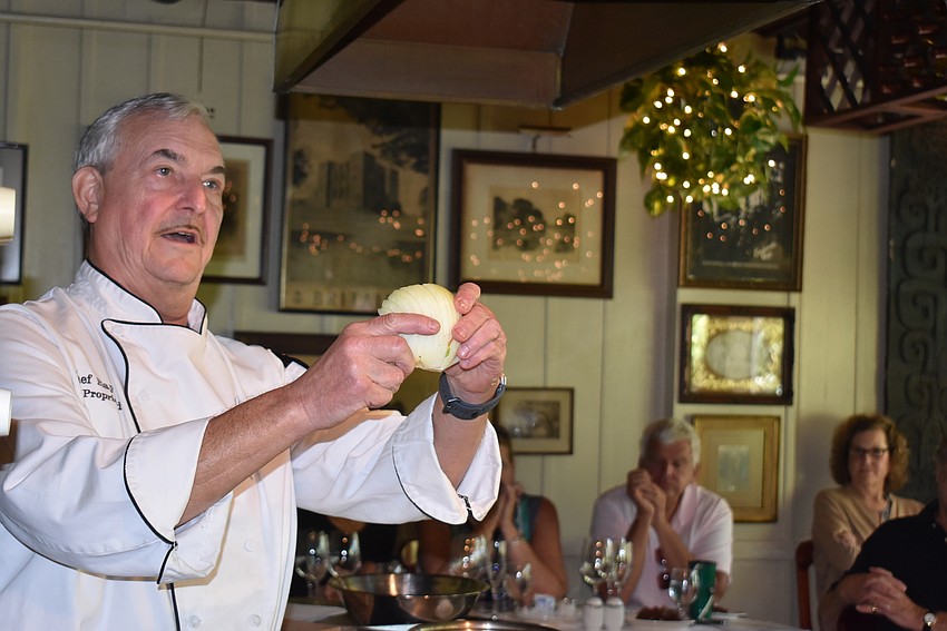 Arpke demonstrates how to cut an onion.