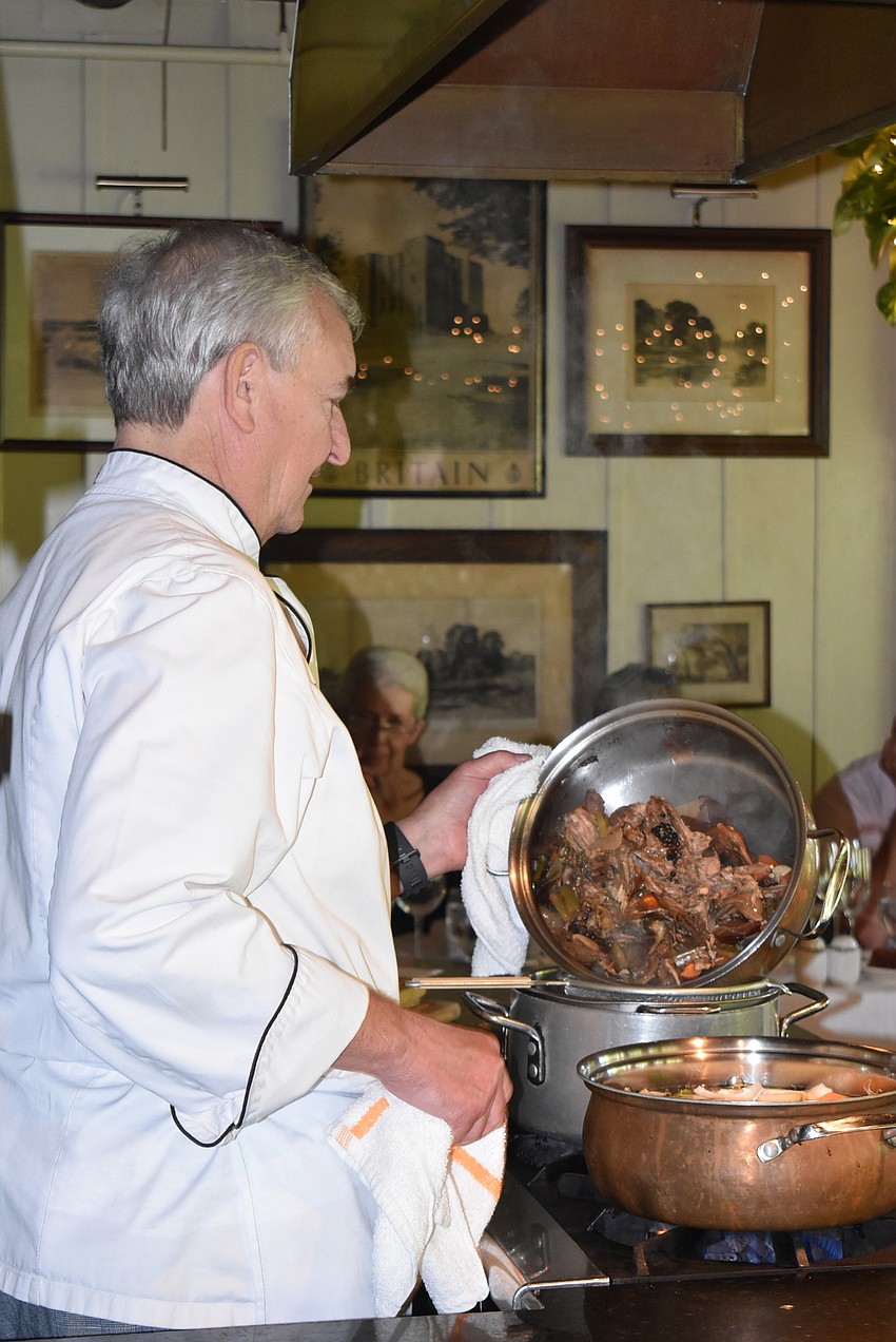 Arpke empties the ingredients into the stock pot.