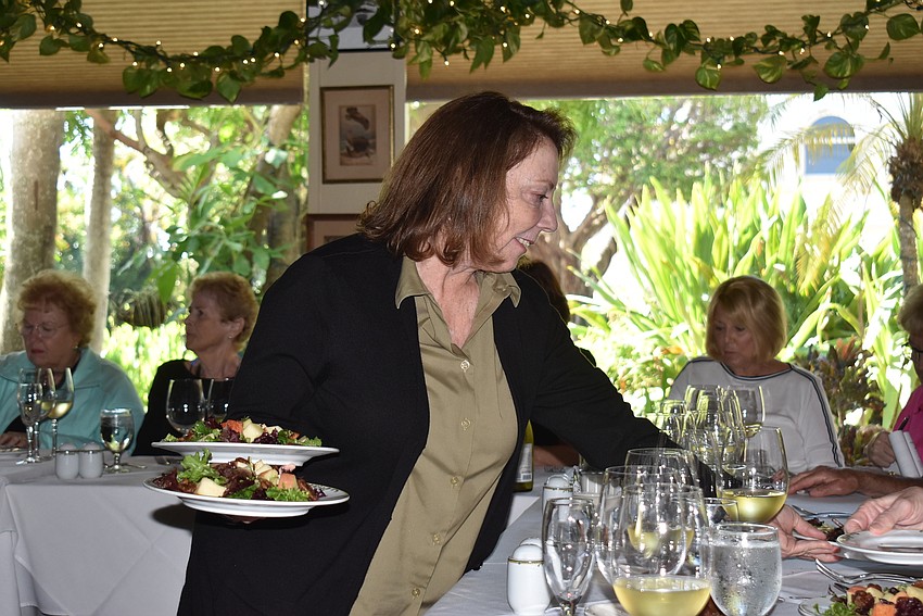 D'Arcy Arpke helps bring out plates.