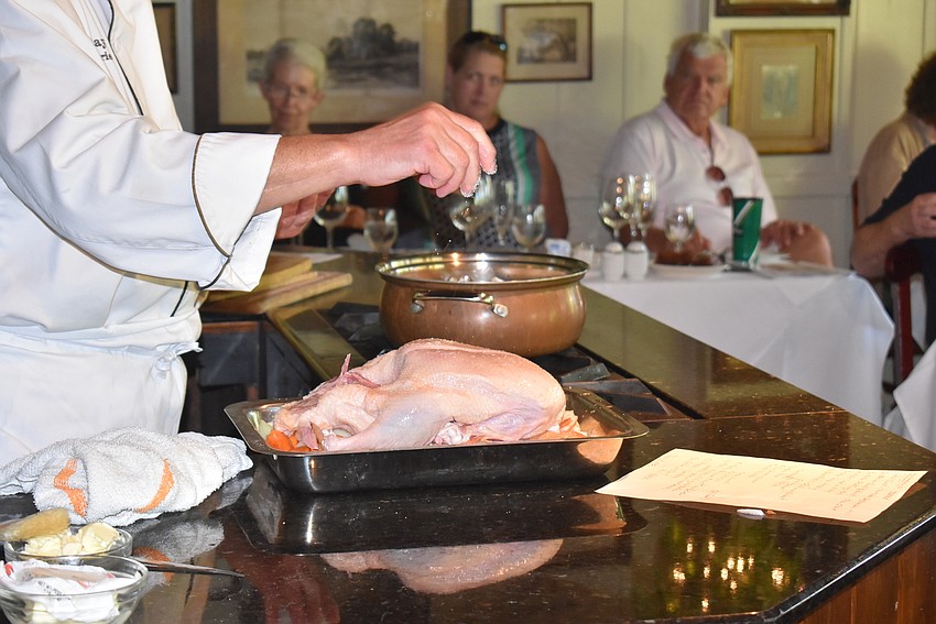 Arpke sprinkles seasonings on the duck. The trick is to sprinkle, not rub, otherwise you'll end up with an ugly duckling, he said.