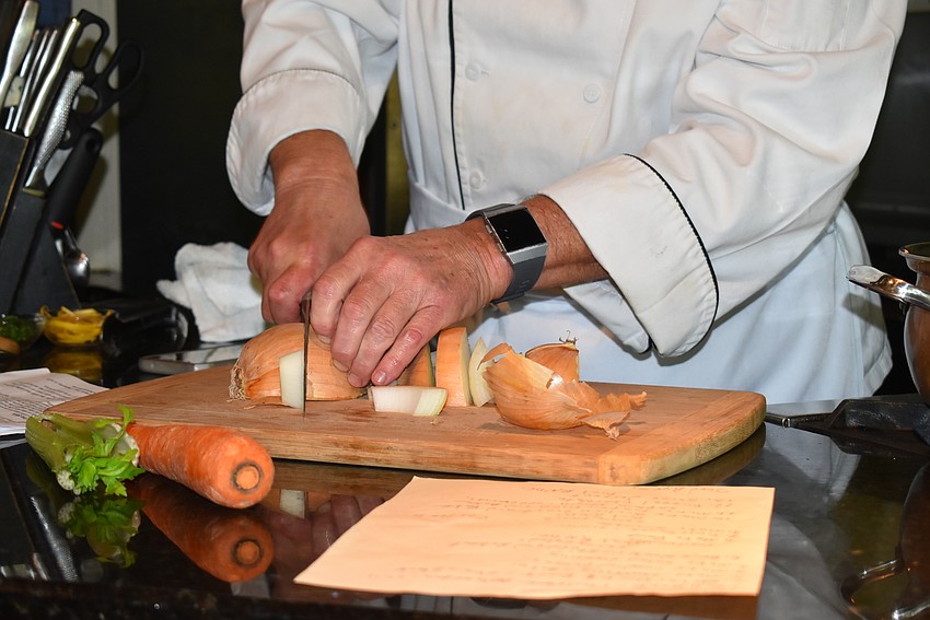 Arpke carefully cuts his vegetables.