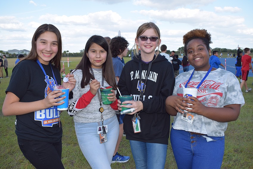 Kathryn Campbell, Yesenia Alvarado-Rios, Claire Van Nortwick and Faith Blash, all sixth-graders, enjoy Kona Ice. The girls chose flavors such as coconut, blue raspberry, cherry, tiger blend and cotton candy.