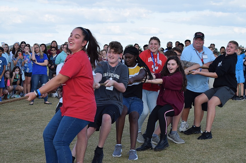 Eighth-graders gather all their strength to defeat teachers and staff members in a round of tug of war.