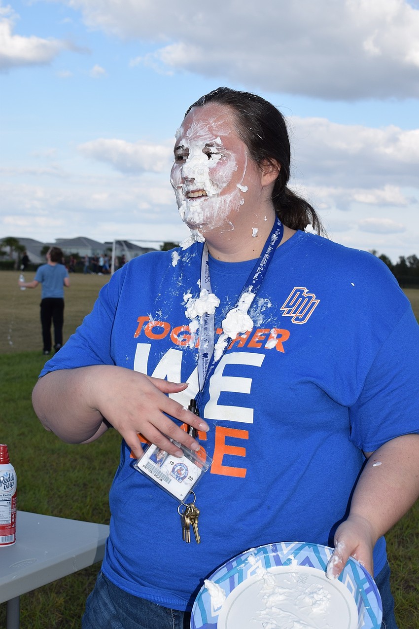 Students paid $2 to shove whipped cream in science teacher Brittany Delvin's face.
