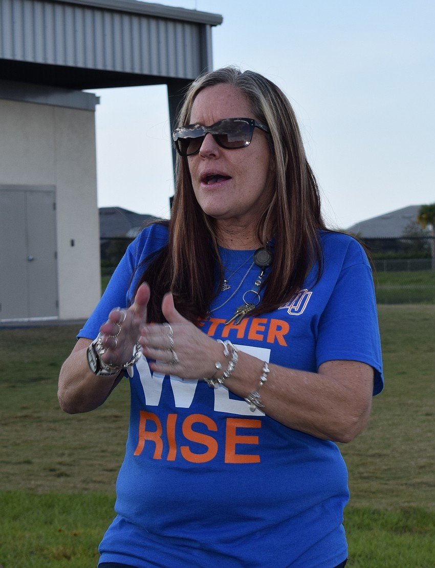 Wende Wicks, a reading teacher, claps along to DNCE's 