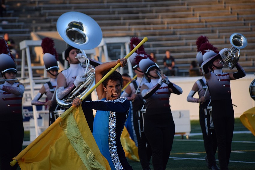Juan Brito, a Braden River senior, captures the audience's attention with his flag .